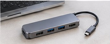 Kompakter USB-C-Hub neben einem Laptop auf einem Schreibtisch